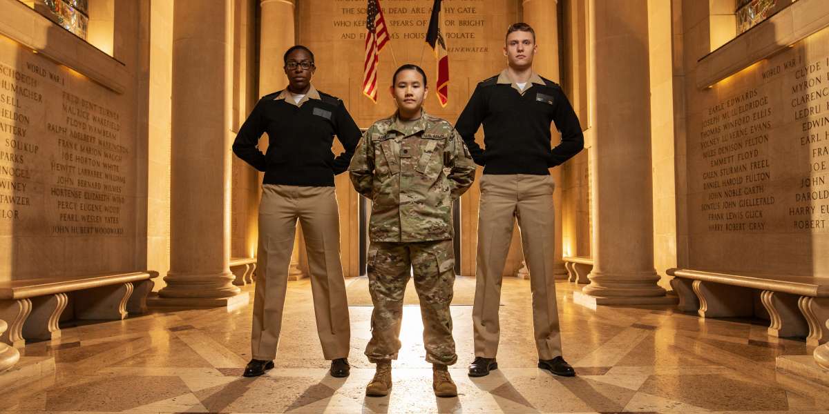 Three military students standing in Gold Star Hall